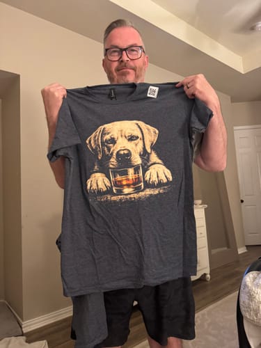 Customer holding up the grey Whiskey Yellow Lab Grunge T-Shirt, displaying the dog and whiskey glass graphic.