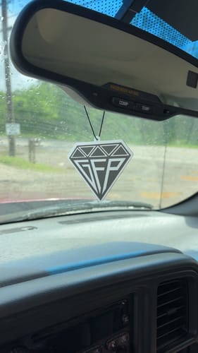 Customer's diamond-shaped GFP Air Freshener hanging from a car's rearview mirror.