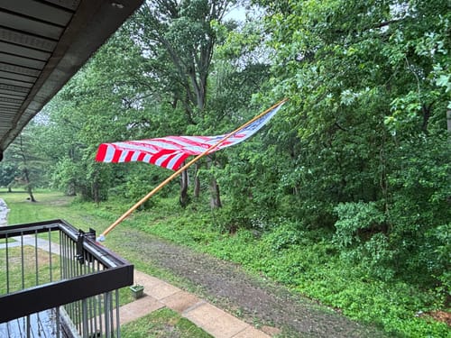 Customer's Heavy Duty American Nylon Flag wrapped around its pole during wind and rain.