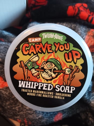 Reviewer's close-up of the Camp Carve You Up Whipped Soap container, showing the colorful, horror-themed label.