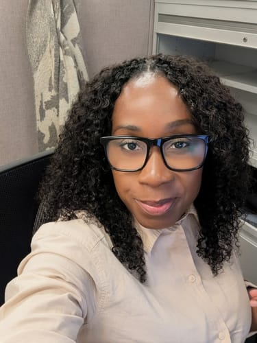 Reviewer wearing a full install of Ywigs Water Curly crochet hair. The dark, curly hair is styled with volume to the shoulders.