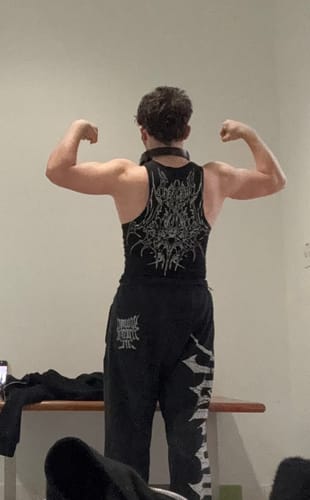 Customer from behind showing the intricate back graphic of the Dark Wave Wife Lovers tank top.