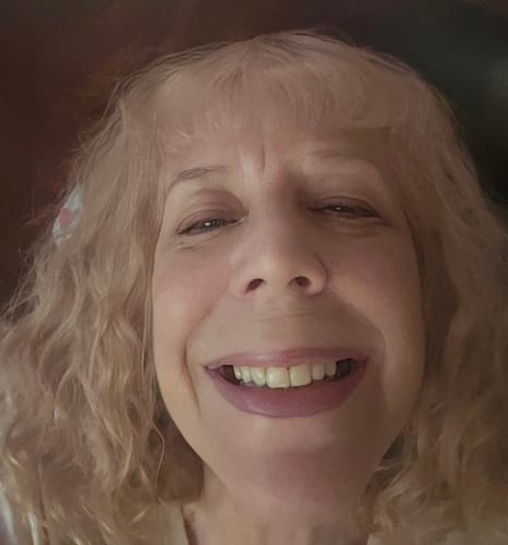 Close-up of a reviewer smiling to show the results of the Korean Silk Collagen Ampoule on her skin.