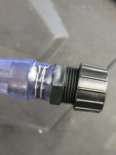 Customer's close-up of a wire clamp added to the nozzle of a 5 Gallon Jug to fix a leak.