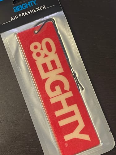 Customer's red 80Eighty Air Freshener in its sealed plastic packaging.
