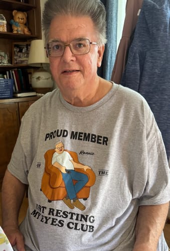 Reviewer wearing the grey personalized 'Just Resting My Eyes Club' shirt.
