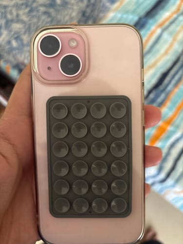 Reviewer's hand holding a pink iPhone in the Anti Yellow Magsafe Clear Case, showing its fit and camera protection.