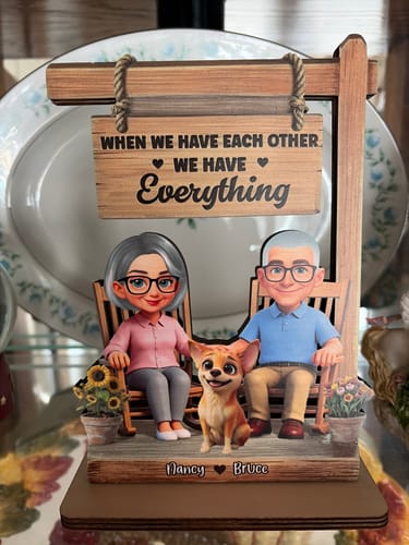 Customer's personalized wooden plaque showing a couple in rocking chairs with a dog and a sign that says, "When we have each other We have Everything".