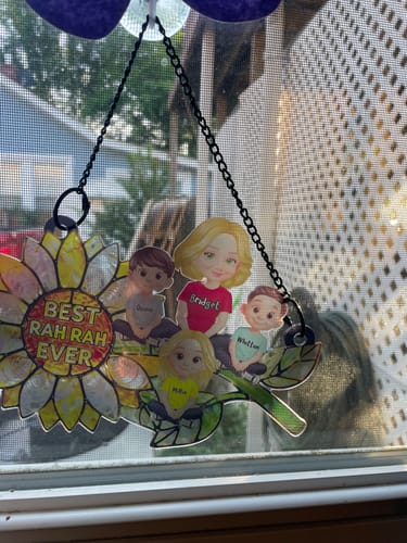 Close-up of a reviewer's personalized sunflower suncatcher showing the custom mom and kids figures.