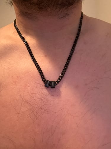 Customer wearing the black stainless steel Legacy Necklace with two personalized beads.