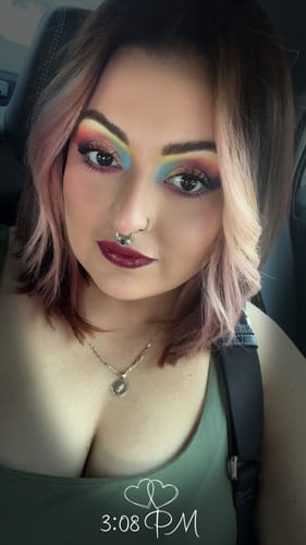 Reviewer wears a vibrant rainbow eyeshadow look using the Creative Comeback XXXL Eyeshadow Palette.