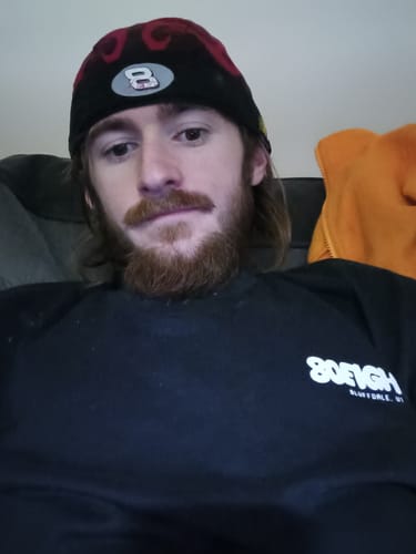 Close-up of a reviewer wearing the black 80Eighty Lil’ Sparky Shirt, showing the chest logo.