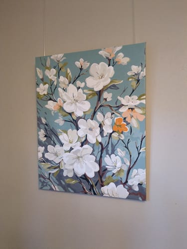 Close-up of a customer's completed Spring Blossom Tapestry hanging on a wall.