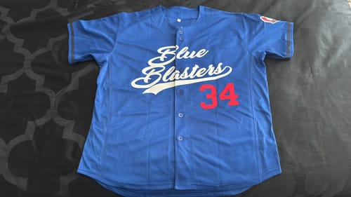 Customer's custom blue baseball jersey with 'Blue Blasters' and red number 34 on the front.