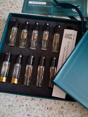 Reviewer's open Discovery Set box showing ten small perfume sample vials neatly arranged inside.