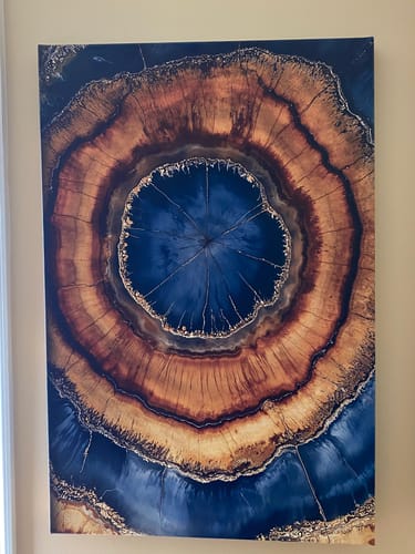 Close-up of the customer's Geode Pulse wall art, showing the abstract blue and amber design.