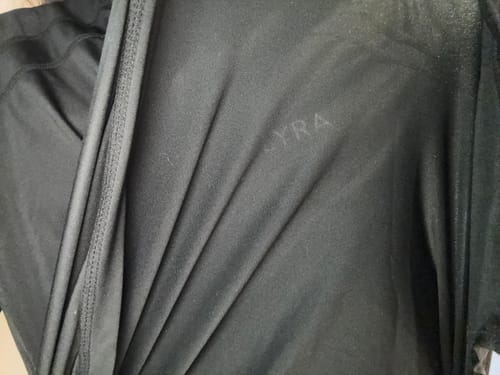 Close-up: Customer's black Modest Active Top, showing the thin, lightweight material and stitching detail.