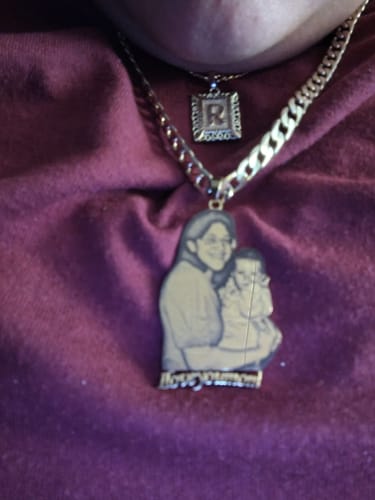Customer wearing the gold-toned Custom Photo Engraved Pendant Necklace. The pendant shows an image of a woman holding a baby.