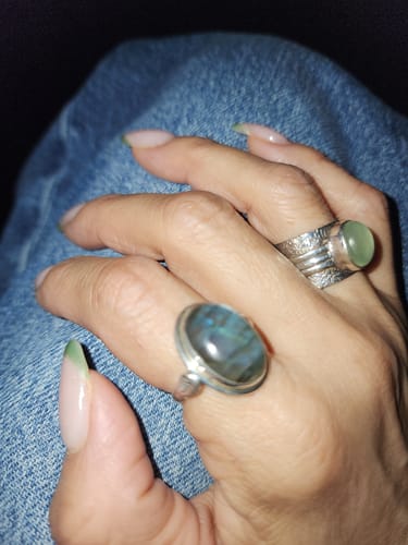 Close-up of a customer's hand wearing the oval Labradorite Leaf Ring.
