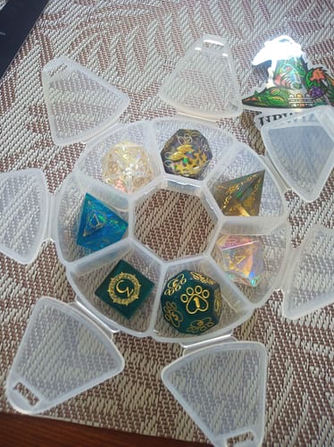 Customer's assorted unique dice from a Mystery Dice Blind Bag, displayed in a clear segmented case.