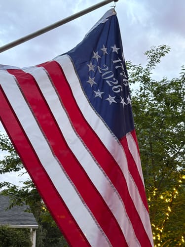Customer's commemorative American flag with '1776' and '2026' embroidered in a circle of stars.