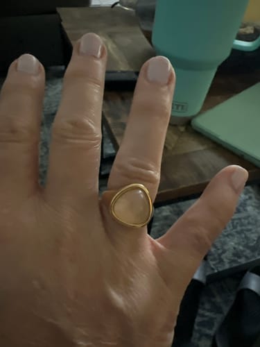 Reviewer's hand wearing the chunky Alaula Gemstone Bold Ring with its large, light pink stone.