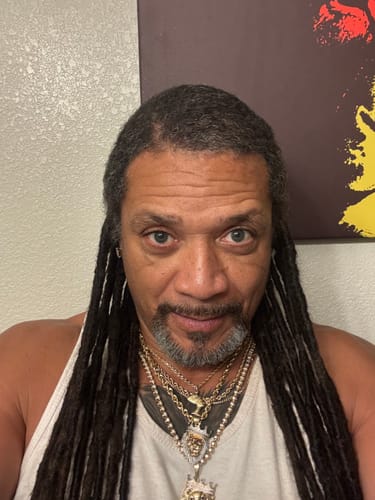 Customer selfie showing their hairline and dreadlocks after using Rennora Hair Growth Serum.