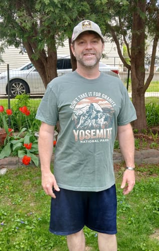 Customer wearing the green Yosemite Granite T-Shirt outdoors.