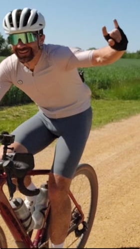 Reviewer cycling outdoors while wearing the gray LIFTTINT 2.X BIB SHORTS.