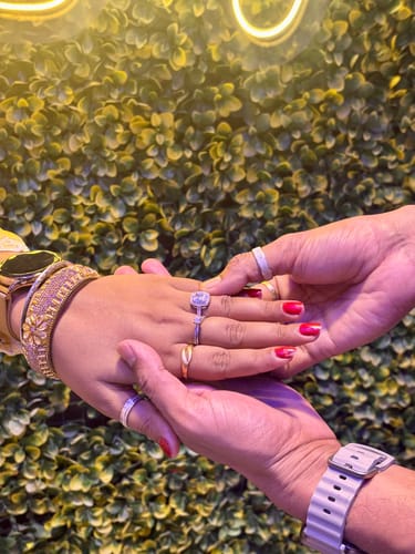 Customer wearing the elegant Silver Classic Solitaire Ring on their finger, with their hand held by another person.