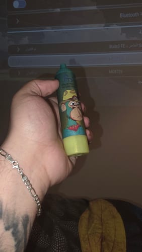 Customer holding the RandM Tornado 15000 Disposable Vape, showing its cartoon monkey design.
