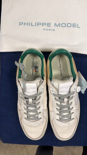 Reviewer's top-down view of the off-white Philippe Model Paris "Pgal" Sneakers with green details, shown with the dust bag.