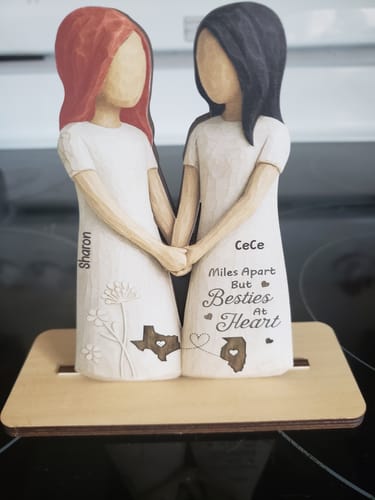 Customer's personalized wooden plaque showing two figures holding hands, customized with names and state outlines.
