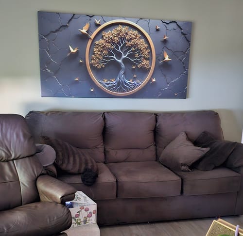 Reviewer's Celtic Tree of Life Wall Art hanging on the wall above their brown couch.