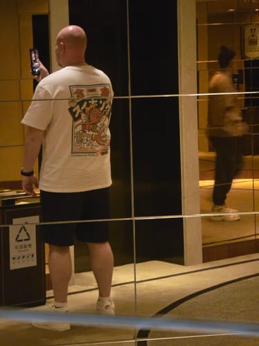 Reviewer, seen from behind, wearing the white Koi King T-Shirt with its large Japanese-inspired graphic.