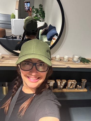Reviewer smiling while wearing glasses and My Amazing Lashes Mascara.