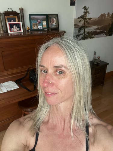 Customer's selfie showing her face and straight grey hair, submitted with her review.