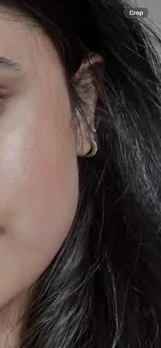 Close-up of a customer wearing the Faux Hoop Crystal Flatback Gold earring in their earlobe.