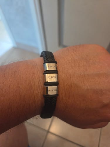 Reviewer wearing the black braided Viking bracelet with three engraved name beads on their wrist.