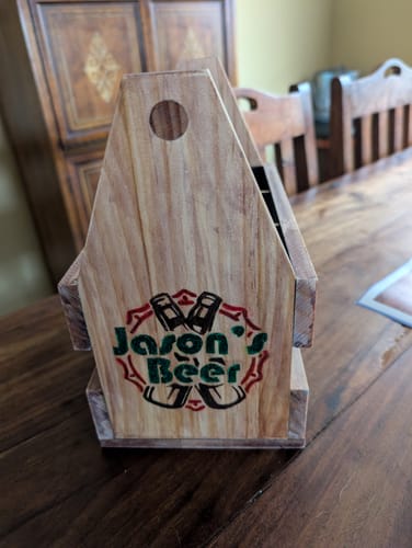 Customer's finished DIY craft beer holder with a custom 'Jason's Beer' logo wood-burned on the end.