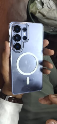 Reviewer holding a purple phone in a clear case in a review for the UltraShield Tempered Glass.