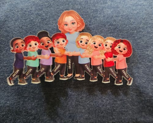 Customer's personalized acrylic fridge magnet showing a grandma character and eight grandchild characters hugging in a line.