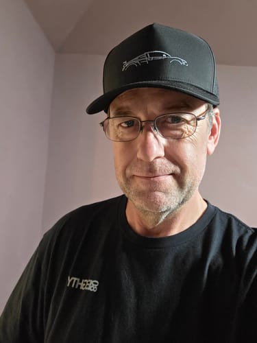 Reviewer wearing the black 80Eighty® Limited Edition DCG89 Hat in a close-up selfie.