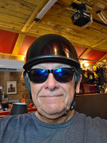 Reviewer wearing the glossy black Switchback DOT Reversible Helmet and sunglasses indoors.