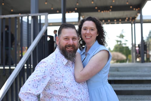 Reviewer smiling in the floral Cherry Blossom Dress Shirt, posing with a woman outdoors.