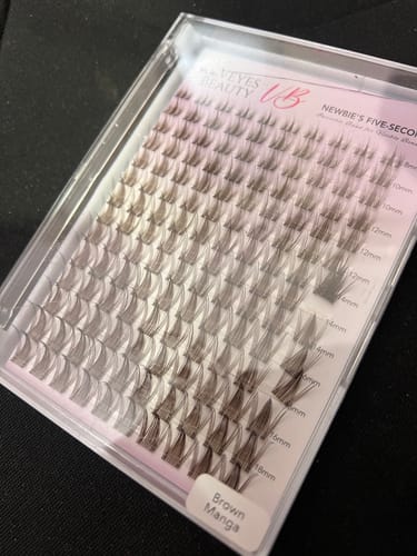 Reviewer's tray of Manga - Brown lash clusters, neatly organized by length in the original clear packaging.