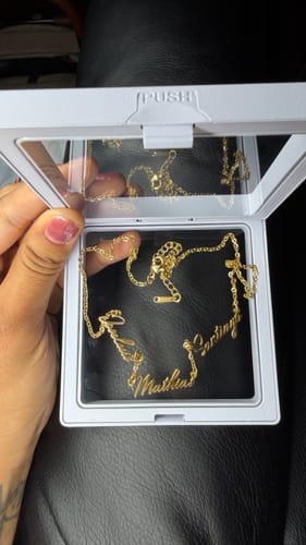 Customer's gold Multi Name Necklace with three scripted names inside a white display box.