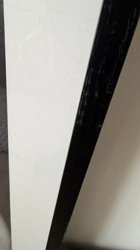 Close-up of a reviewer's damaged Black Oak Gallery Frame, showing scratches along the edge.