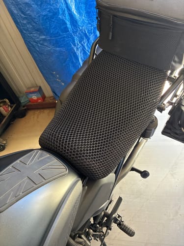 Customer's black, mesh Wind Rider Seat Cover installed on a motorcycle seat, viewed from a high angle.