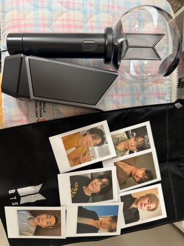 Customer's BTS Official Light Stick Ver.4 and Cradle with included instant photos of band members.